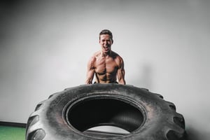 man-lifts-tire-exercise